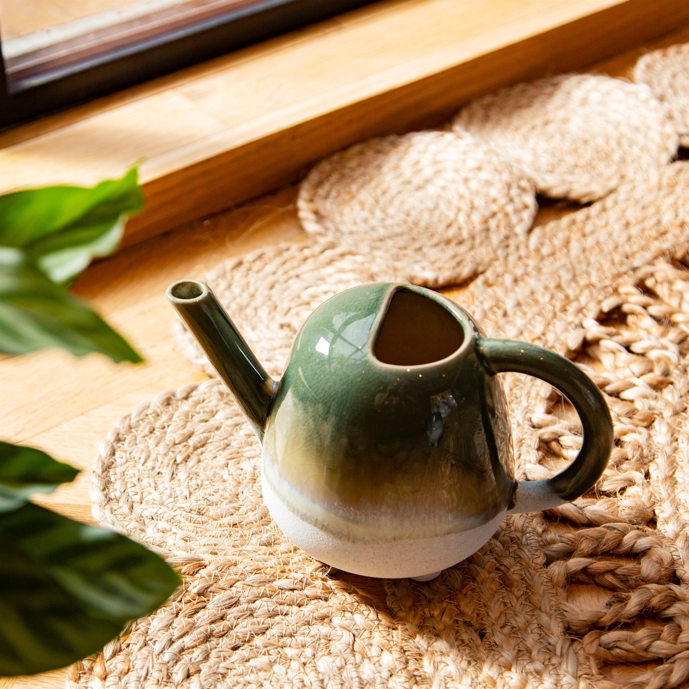 Decorative green indoor watering can